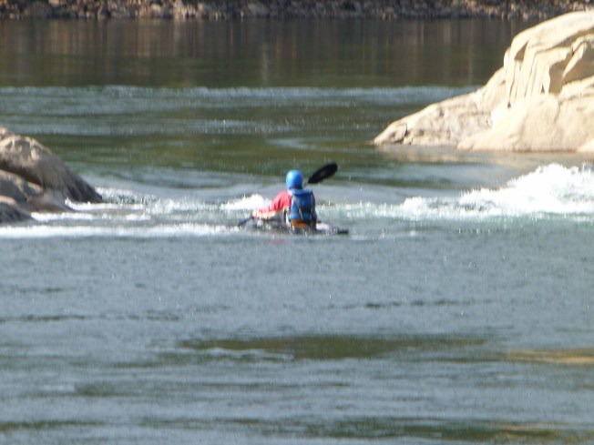 A Kayaker practicing white-watering